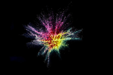 Colored powder explosion. Abstract closeup dust on backdrop. Colorful explode. Paint holi