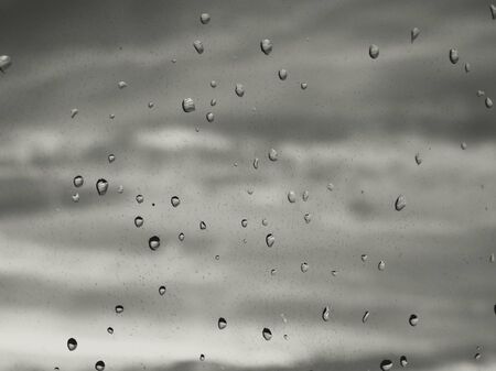 Rain drops on glass minimalism abstract water black white weather depressionの写真素材