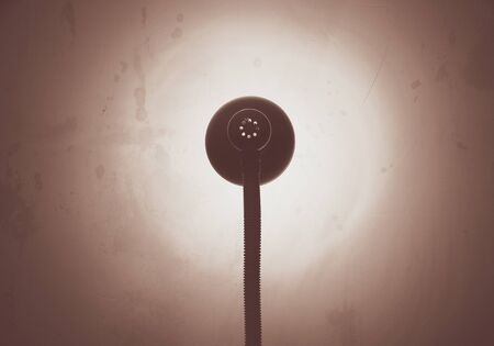 A night lamp against a wall textures light background wallpaper night Illumination minimalism abstractの写真素材