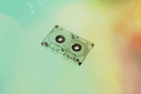 Audio cassette on background wallpaper textures retro old vintage melody nostalgia modern time 70s 80s 90s generation song sound top hits music texture colorful paint listen.の写真素材