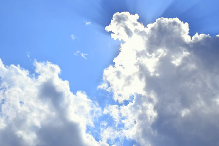 the rays of the sun from the clouds against the blue sky