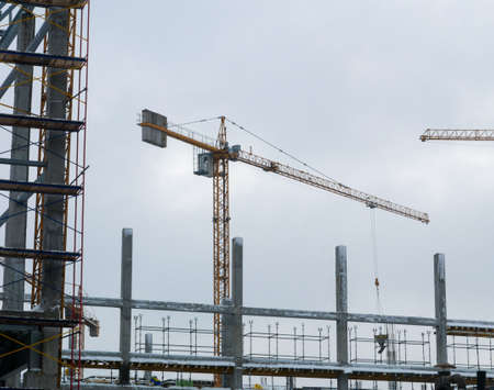 Construction crane working tower building city photoの写真素材