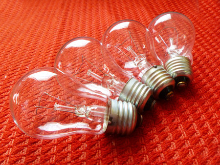 Electric light bulbs on red background