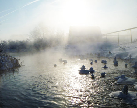 Misty morning on river in winter