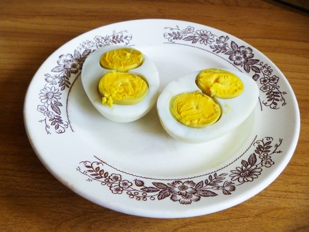Egg with two yolks on plateの写真素材