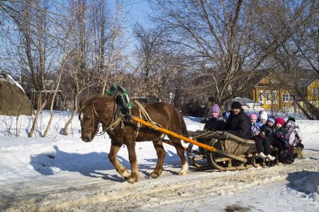 The Shrovetide. Walk of the boys on vehicle with horseのeditorial素材