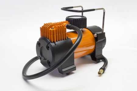 Orange electric compressor for car on light backgroundの写真素材