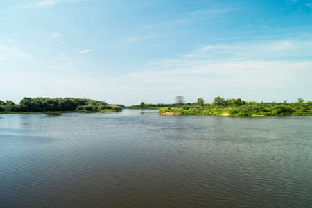Beautiful river landscape by summer with green tree ashoreの写真素材
