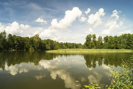Year landscape with river in rural terrain on background blue skyの写真素材