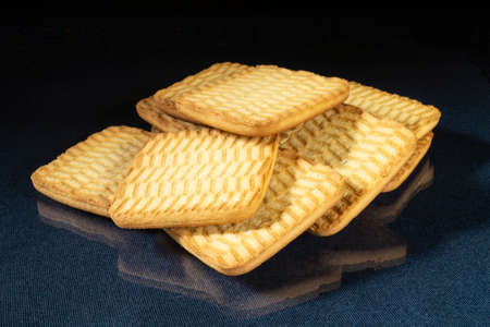 The Sweet cookie to tea on table with reflection. Products of the feeding on black backgroundの写真素材