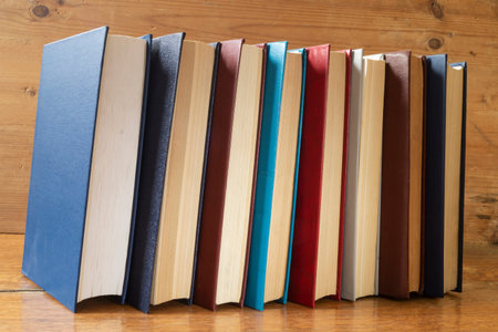The Stack of the books rests upon wooden regiment. Subjects in closet close-up