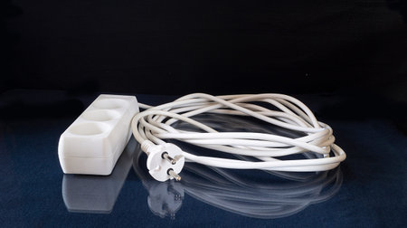 Network extension Cable rests upon glass table with reflection. Subjects on black background...