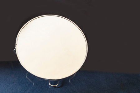 The Round mirror on glass table with reflection. Subjects for building on black background