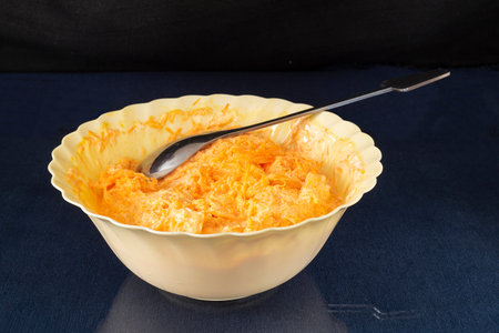 The Carrot with mayonnaise and garlic in plate on glass table. Products of the feeding on black...