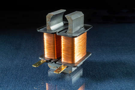 Electric condenser for household appliances on the table with reflection. Industrial parts on a black backgroundの写真素材