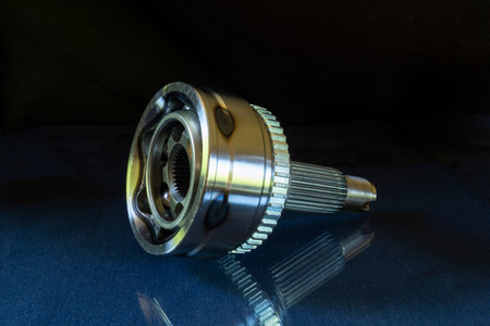 A bearing of equal angular velocities for a car. Metal details on a black background.New parts for repairの写真素材