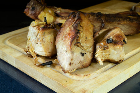 Fried pieces of meat on a wooden board. food on a black backgroundの写真素材