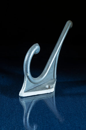 An old object in close-up on a black background. A device for storing clothes