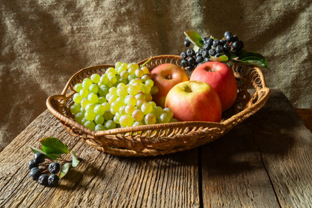 Still life of ripe fruits and berries on an old board. Food products on the background of burlapの写真素材