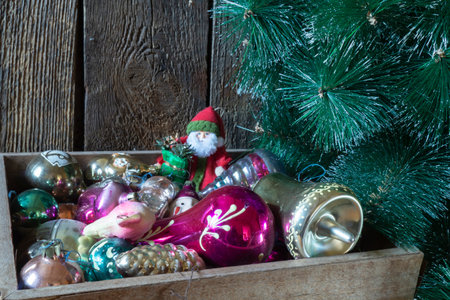 Festive decorations for the Christmas tree close-up. Still life with Christmas tree toys on the background of old boardsの写真素材