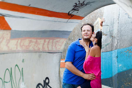 latin girl kissing her boyfriendの写真素材