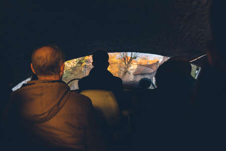 Tourists sailing in the water city canal. Silhouette of people in a boat passing under the bridge.の写真素材