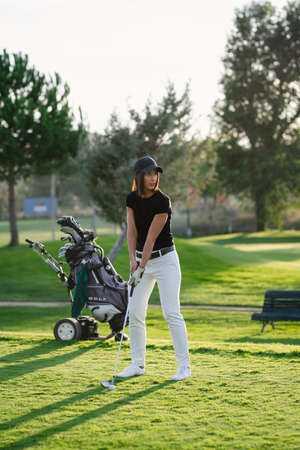 Woman playing golf on beautiful golf courseの写真素材