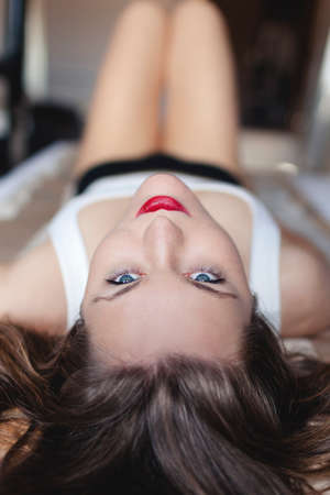 A close up of a young woman laying on a divanの写真素材