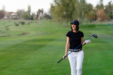 middle-aged woman walks on the golf courseの写真素材