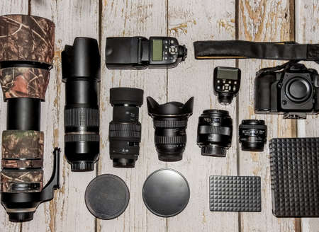 aerial view of professional photographic equipment with reflex camera, lenses, filters and flashの写真素材