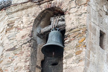 bell of a church steeple fastened with an old wooden anchoring systemの写真素材