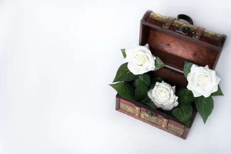Small beautiful chest with white roses inside.