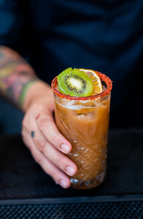 Orange and kiwi cocktail frosted with chili