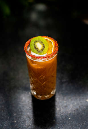 Orange and kiwi cocktail frosted with chiliの写真素材