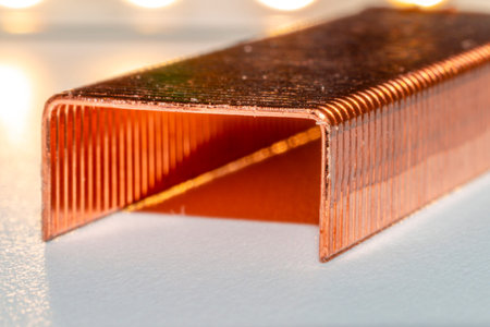 Coppered staples photographed close-up in white tones. Group of copper staples placed diagonally as...