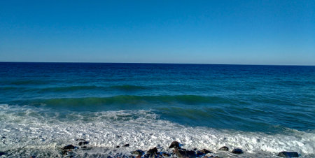 Contrasts of blue colors on a stony beach