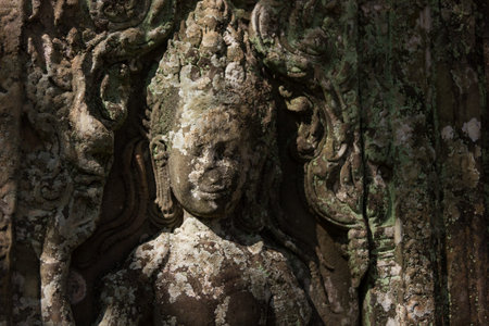Detail of a carved deity devata in the temple of Angkor Wat Cambodiaの写真素材
