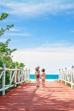 Two little girls walking to the beachの写真素材