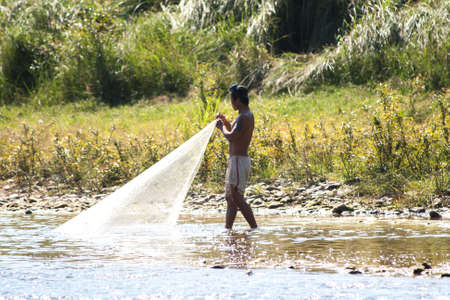 Unidentified laotian fisherman near Song river, Vang Vieng, Laos.のeditorial素材