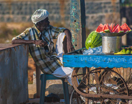 Man selling fresh fruits on the beach in Mamallapuram, Tamil Nadu, India.のeditorial素材