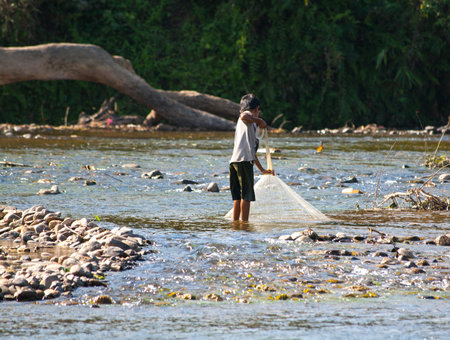 Unidentified laotian fisherman near Song river, Vang Vieng, Laos