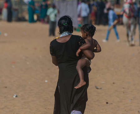 Woman and her daughter on the beach Mamallapuram, Tamil Nadu, India.のeditorial素材