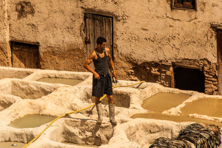 Man at work in a tannery in Fez, Morocco