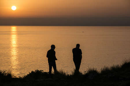 Men at sunset in italyの写真素材