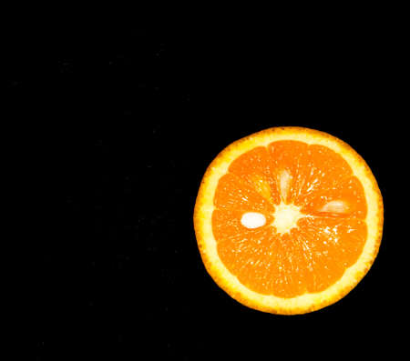 Orange isolated on black backgroundの写真素材
