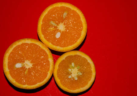 Oranges isolated on red backgroundの写真素材
