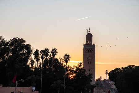 view of Koutoubia Mosque at sunset (Kutubiyya or Jami 'al-Kutubiyah Mosque) the largest mosque...