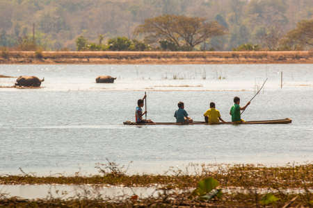 children in a canoe on Bungva lake, Savannakhet, Laos.のeditorial素材