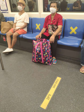 social distancing during Covid-19 pandemic on public transport (BTS train), Bangkok, Thailandのeditorial素材