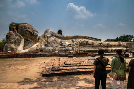 tourists near lying buddha in Wat Lokkayasutharam (Phra Buddha Sai Yat), at Buddhist temple of archaeological park, Ayutthaya, Thailandのeditorial素材